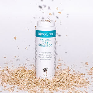 MooGoo Dry Shampoo with oat flakes falling around it