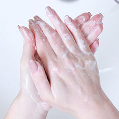 Woman washing hands with soap