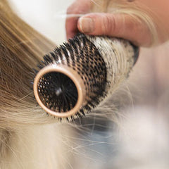 round bristle brush brushing blonde hair