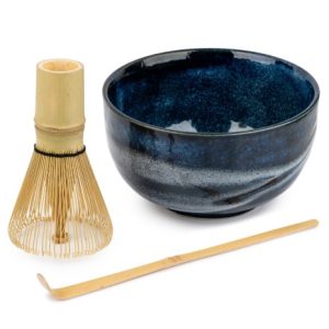 Dark blue matcha tea bowl with bamboo whisk and bamboo spoon.
