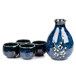 Navy blue sake glass with white cherry blossom design and four matching sake glasses.