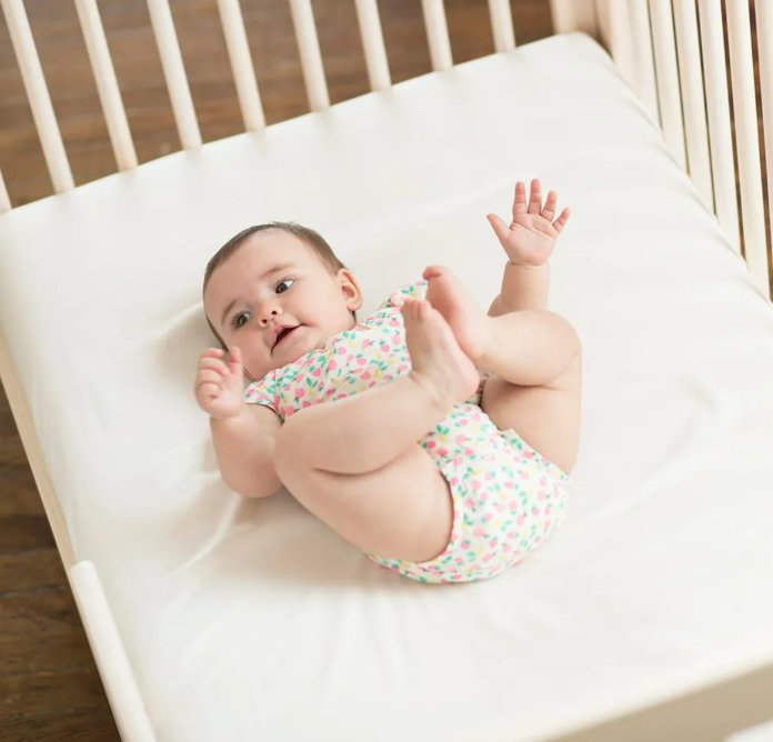 Baby on Naturepedic Crib Sheets