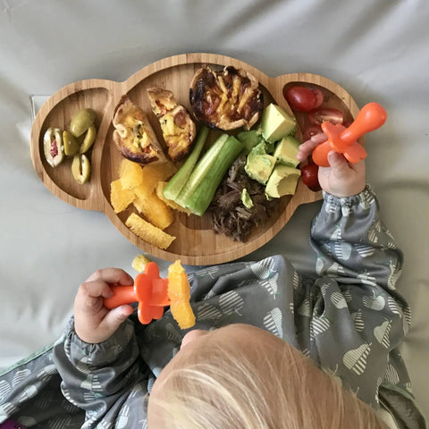 A koala shaped plate with a toddlers lunch on it, shot from above. 