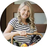 Lucy Beynon, nutritionist looking at the camera showing a basket of food