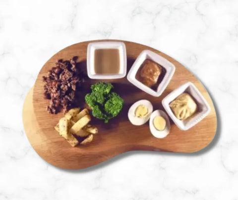 A cutting board with iron rich foods needed to meet a babies daily iron requirements.