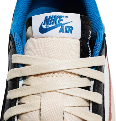 The Fragment Design x Travis Scott x Air Jordan 1 Retro Low delivers a collaboration that blends signature details associated with both La Flame and Hiroshi Fujiwara’s influential imprint. The color palette is reminiscent of past Fragment joint ventures, highlighted by a white leather upper with contrasting overlays in black and royal blue. Scott’s inverted and oversized Swoosh decorates the lateral side panel in an off-white finish, while a standard black Swoosh is stitched onto the opposite side. Cactus Jack branding adorns the heel tab of the left shoe, along with the rapper’s smiley face logo stamped directly underneath. On the heel of the right shoe, a classic Jordan Wings logo is joined by Fragment’s lightning bolt trademark.