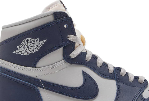 Restored with a heritage build, the Air Jordan 1 Retro High '85 OG ‘Georgetown’ features a familiar two-tone design that celebrates the 40th anniversary of Michael Jordan’s title-clinching shot against the Hoyas on March 29, 1982. The all-leather upper pairs a light grey base with contrasting overlays in College Navy. A woven Nike Air tag adorns the nylon tongue, while a retro Wings logo is stamped on the lateral ankle. The high-top is mounted on a traditional rubber cupsole, fitted with an Air-sole heel unit encapsulated in lightweight polyurethane.