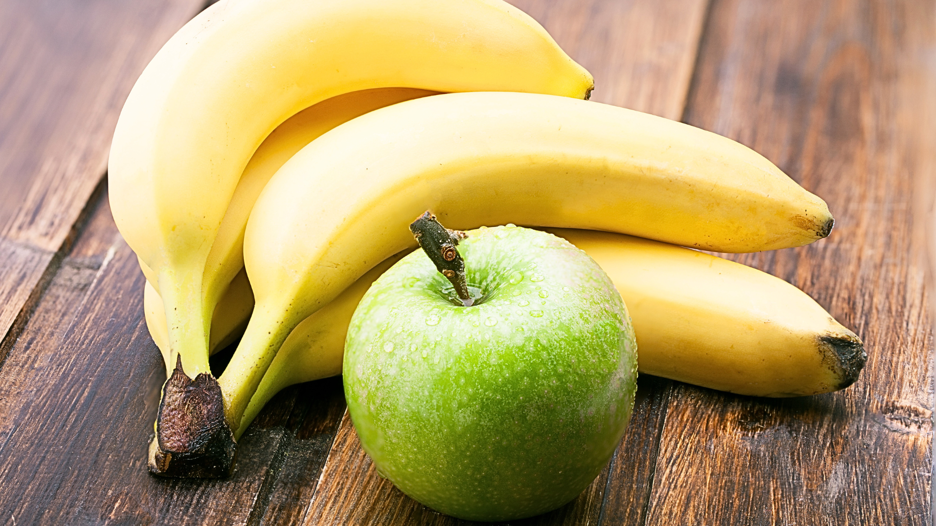 Apples and bananas on a table.