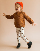 Baby wearing a brown popcorn sweater, peanut leggings and forest green Glerups Wool Baby Boots