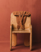 Noble Sun Suit in Cinnamon color draped over the back of a chair