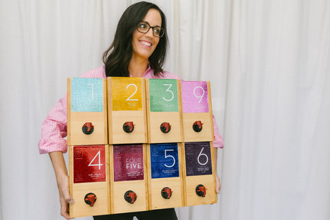 Founder of eco-friendly winery @drinkboxt, holding her 8 Limited Reserve Release wines