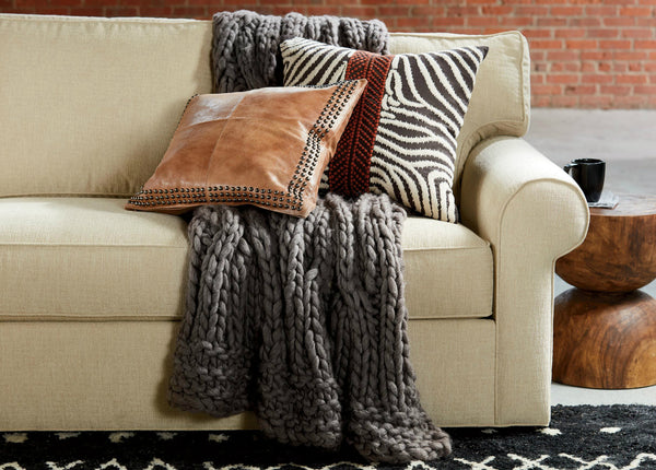 hosting must haves comfortable couch with pillows and blankets