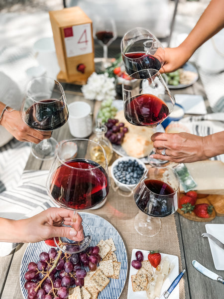 boxt wine in glasses as people toast