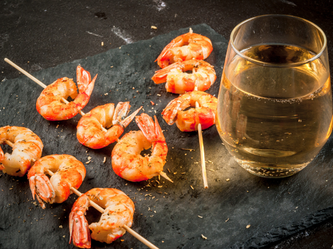 shrimp skewers and a glass of white wine