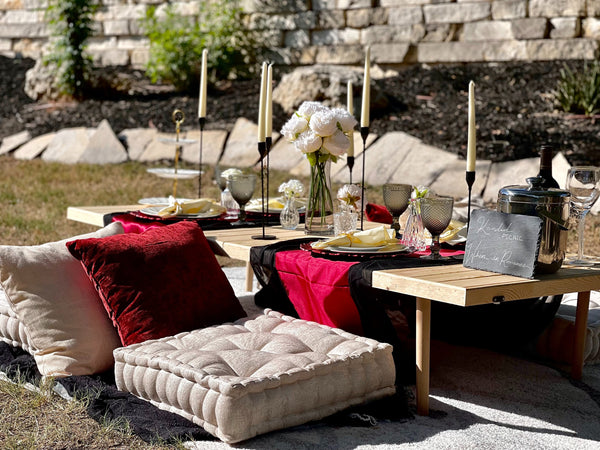 luxury backyard picnic with wine and pillows