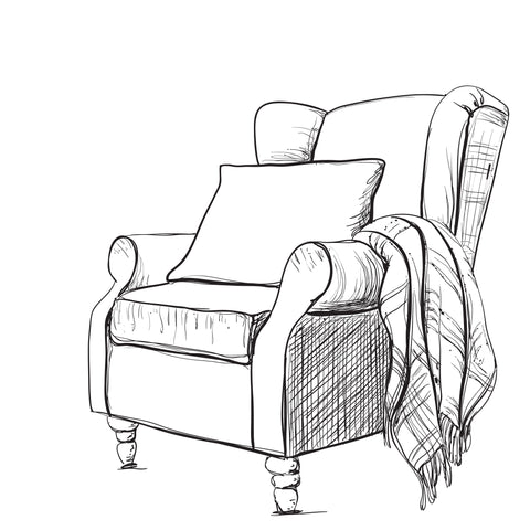 A comfy chair with a pillow and a blanket. Perfect for settling into a quiet moment. 