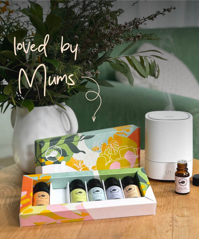 Loved by Mums. Home Sanctuary Oil Kit displayed on coffeee table with diffuser and flowers. Mother's Day Gift Idea