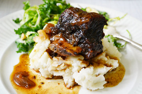 Braised bison short ribs over mashed potatoes.