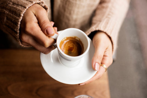 Woman holding coffee.