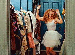 Carrie Bradshaw in Sex and the City, jumping around and smiling