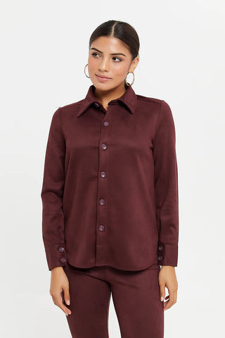 a woman wearing a brown shirt