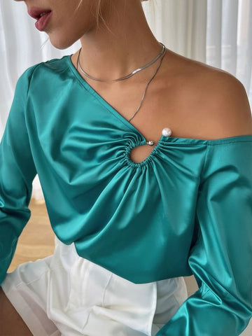 a woman wearing green blouse with front blouse