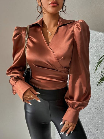 a woman wearing a brown silk blouse