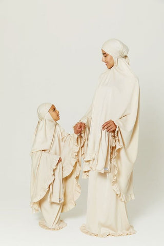 a woman and a her daughter wearing abaya