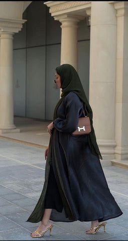 a woman wearing a black abaya