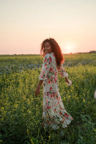a woman wearing a summer dress in sunset