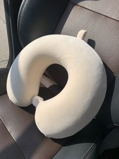 beige neck pillow in car