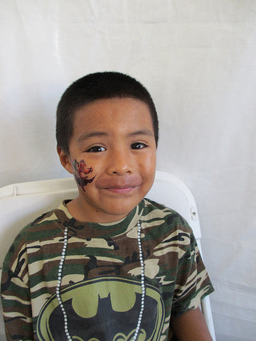 boy smiling after easy face paint tattoo