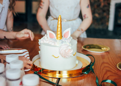 unicorn cake and girl wearing tattoos for kids birthdays