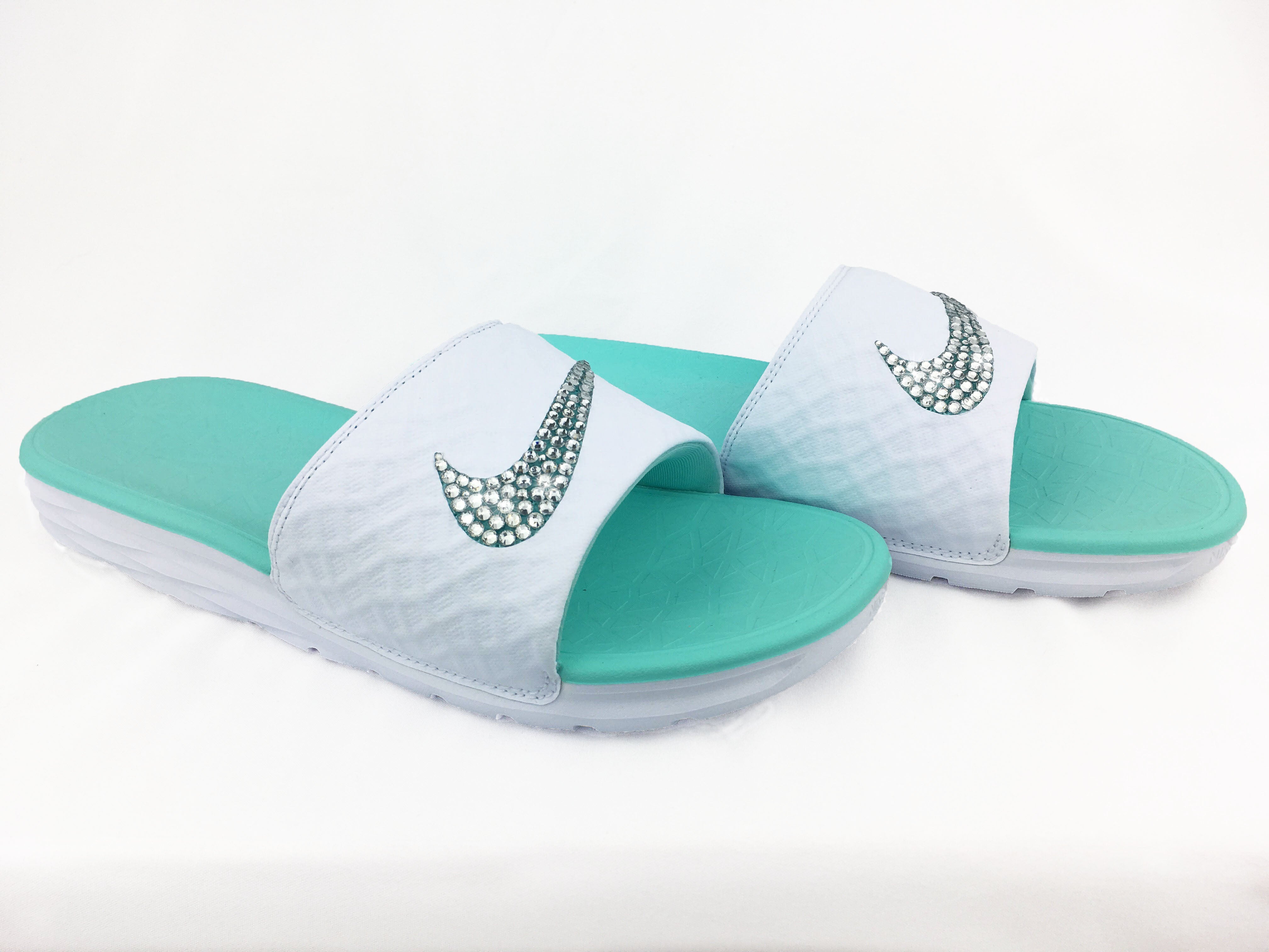 white and teal nike slides