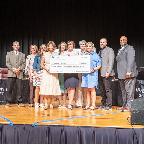 Food for Thought Founder, Tiffanie Nelson, accepts a check from the St. Joe Community Foundation