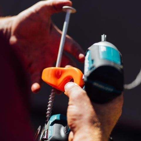 Close up of Ezy Anchor Screw In Tent Peg with hand drill