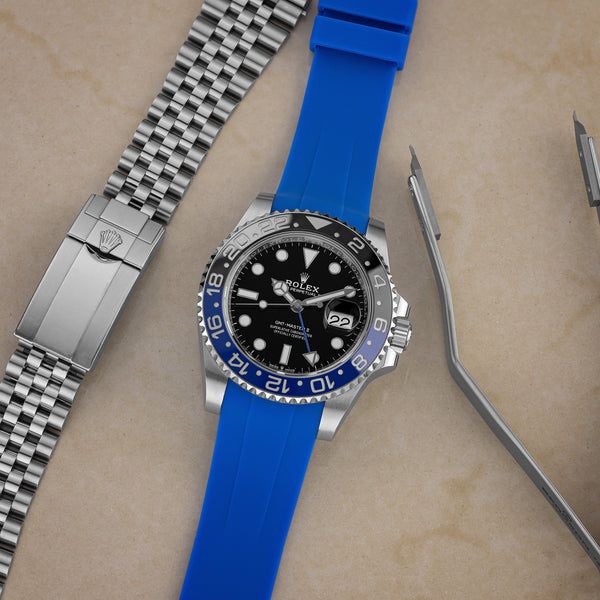 https://cdn.shopify.com/s/files/1/0662/2047/products/rolex-gmt-batman-gulfstream-blue-rubber-band_600x.jpg?v=1617235033