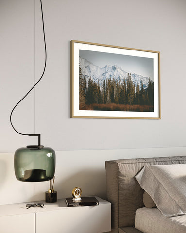 framed wall art in bedroom with matching green lamp