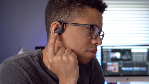 A person adjusting his earbuds