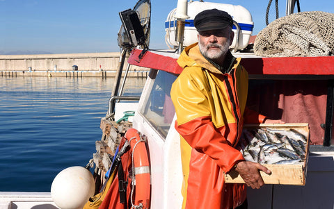 a fisherman on a boat in a harbor