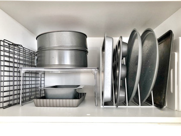 baking trays organised in kitchen cupboard using storage rack