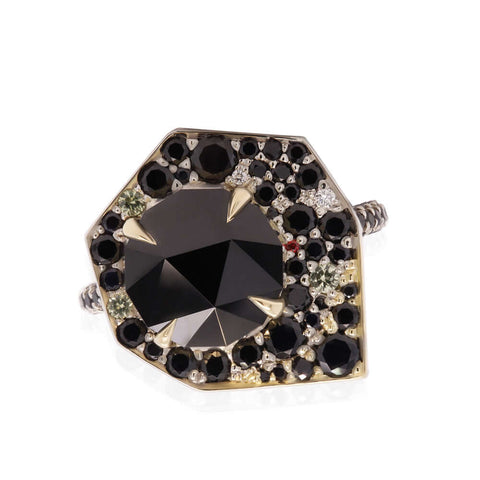 One of a kind statement ring with black spinel center stone, surrounded by a geometric halo with black sapphires melees. Ring is two-tone, white and yellow gold.