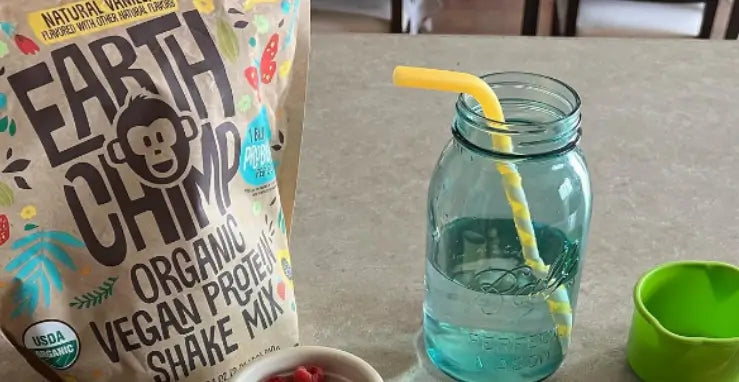 Earth Chimp vegan protein powder next to a mason jar, suggesting different types to enjoy.