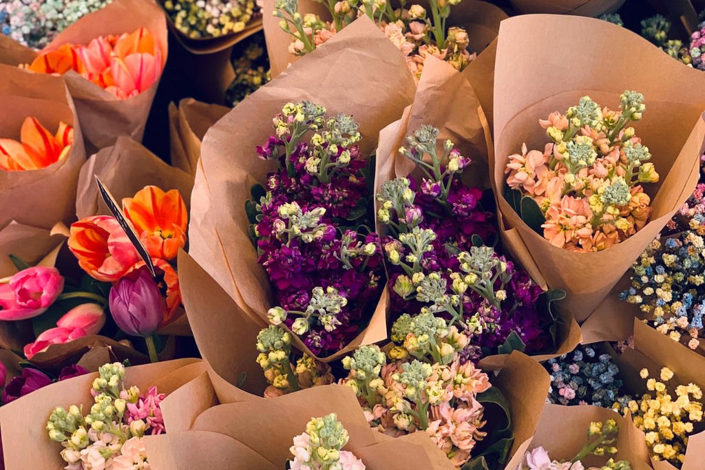 Flower Bouquets wrapped in brown paper filled with colourful blooms