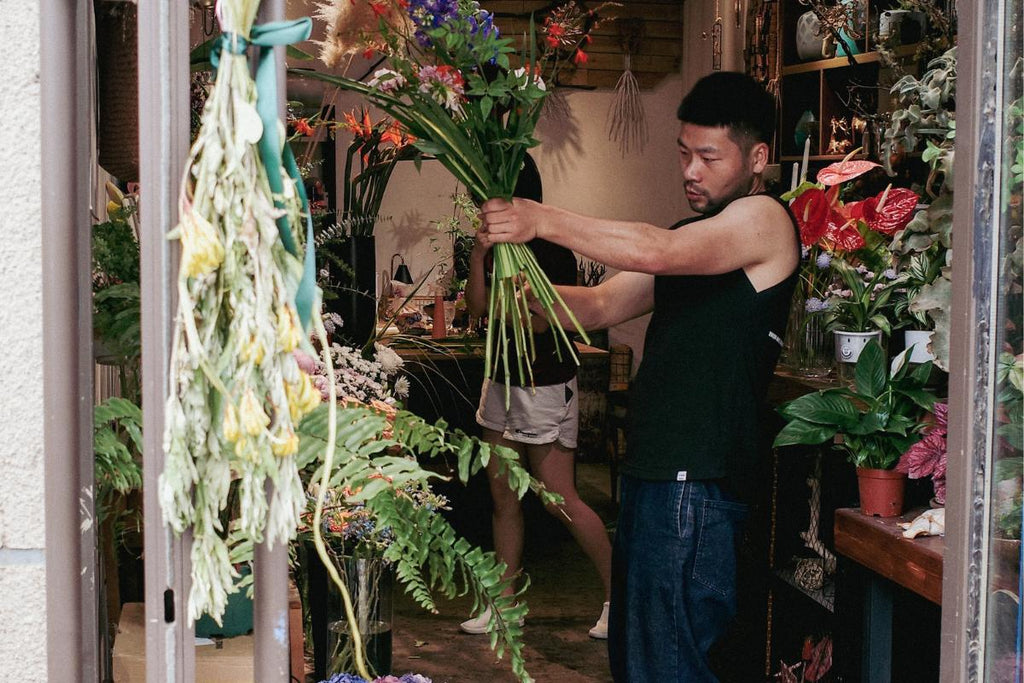 Image of male florist, a flower guy arranging a bouquet