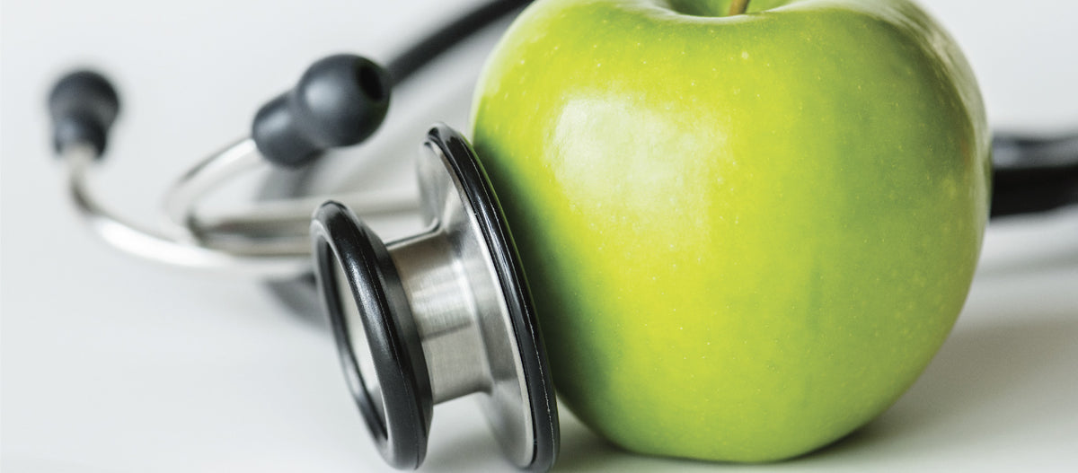 A green apple and a stethoscope