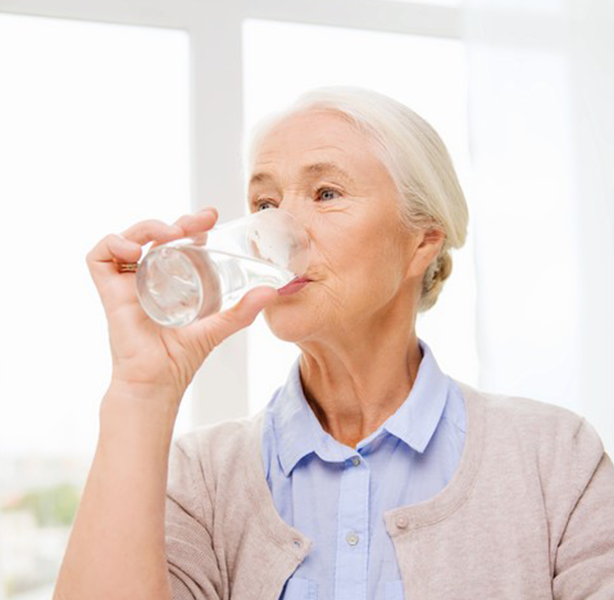 Woman Drinking Water from Glass - BN Healthy