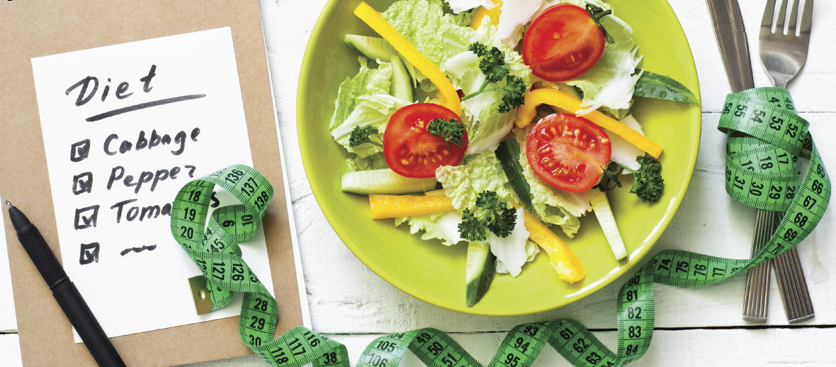Diet list with plate of salad and a tape measure