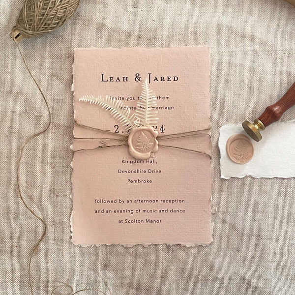 Natural Wedding Invitation made with blush pink handmade paper, wax seal and dried flowers.  Easy to make wedding invitation with handmade paper.  Eco friendly invitation to make at home