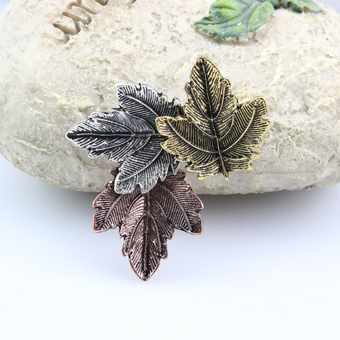 vintage maple leaf brooche on a white stone